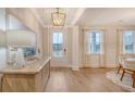 Bright foyer featuring light wood floors, an elegant light fixture, and large windows with sheer curtains at 217 Bilge Rd, Ridgeville, SC 29472