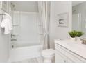 A full bathroom featuring a shower and tub combination, white cabinets, and neutral décor with ample lighting at 267 Garden Gate Way, Summerville, SC 29486