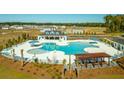 Aerial view of a resort-style community pool with ample lounge seating and a pergola at 293 Blue Haw Dr, Moncks Corner, SC 29461