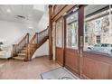 Inviting entryway with staircase, detailed woodwork, and brick accent walls at 3 Queen St # 315, Charleston, SC 29401