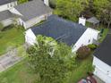 Bird's eye view of a residence with a lush lawn, dark roof, and convenient garage at 308 Burton Ave, Summerville, SC 29485