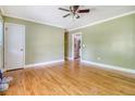 Spacious living room with hardwood flooring leads to a kitchen area at 3143 Bonanza Rd, Charleston, SC 29414