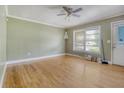 Bright living room features hardwood floors, large window, and ceiling fan at 3143 Bonanza Rd, Charleston, SC 29414