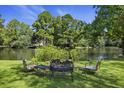 Seating area overlooking the lake with beautiful trees and landscaping at 3168 Stanyarne Dr, Charleston, SC 29414