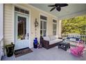 Inviting front porch with comfortable seating, ceiling fan, and a view of the outdoors creating a relaxing space at 3302 Porchview Pl, Johns Island, SC 29455