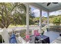 Comfortable porch with rocking chairs and seating with a view of the community and landscaping at 3302 Porchview Pl, Johns Island, SC 29455