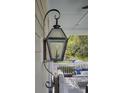 Close up of hanging porch lantern in front of a seating area at 3302 Porchview Pl, Johns Island, SC 29455
