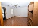 Bright bedroom with hardwood floors, ceiling fan, and a built-in bookshelf for storage at 389 Maggie Rd, Mount Pleasant, SC 29464