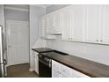 Kitchen area with white cabinets, wood counters, and stainless steel appliances at 45 Sycamore Ave # 1327, Charleston, SC 29407