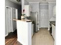 Open kitchen with white cabinets, dark wood counters, and stainless steel appliances at 45 Sycamore Ave # 1327, Charleston, SC 29407