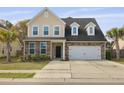 Charming two-story home featuring a stone and vinyl facade, attached garage, and well-maintained lawn at 470 Gianna Ln, Goose Creek, SC 29445