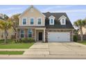 Charming two-story home featuring a stone and vinyl facade, attached garage, and well-maintained lawn at 470 Gianna Ln, Goose Creek, SC 29445