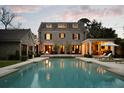 Beautiful backyard pool with lounge chairs and an outdoor seating area at dusk at 478 Huger St, Charleston, SC 29403