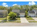 Aerial view of a well-maintained home with a spacious yard, lush trees, and a driveway leading to a two-car garage at 529 Beverly Dr, Summerville, SC 29485