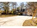 Lovely brick home with an attached two-car garage, surrounded by mature trees on a sunny day at 643 Edmonds Dr, Charleston, SC 29412