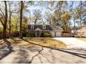 Inviting brick home with dormer windows, surrounded by mature trees and lush landscaping in a quiet neighborhood at 643 Edmonds Dr, Charleston, SC 29412