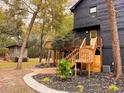 Exterior view showing an outdoor staircase leading to a yellow door at 6464 St Anthony Dr, Hollywood, SC 29449