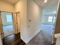 Hallway boasts luxury vinyl plank flooring, leading to spacious rooms filled with natural light at 707 Pisces Ln, Summerville, SC 29486