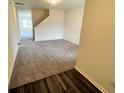 A modern living room with carpeted floors and staircase with luxury vinyl plank entry way at 707 Pisces Ln, Summerville, SC 29486