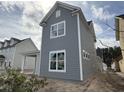 Gray, two-story home featuring white trim and bright windows, as well as a covered carport at 717 Blueway Ave, Summerville, SC 29486
