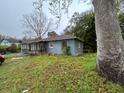 Backyard view of a weathered single-story home needing repair and lawn maintenance at 75 Rentz St, Varnville, SC 29944