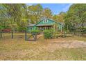 Charming green home with mature landscaping, lush trees, and brick pathway at 755 Jumbo Ln, Edisto Island, SC 29438