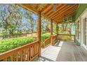 Covered porch showcasing wood ceiling, views of lush landscaping and waterfront at 755 Jumbo Ln, Edisto Island, SC 29438