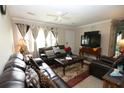Cozy living room featuring comfortable leather furniture, a ceiling fan, and lots of natural light at 7605 Ireland Dr, North Charleston, SC 29420