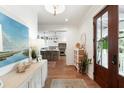 Bright entryway with shiplap walls, wood floors, and view into the modern, updated kitchen at 825 Marsh Grove Ave, Mount Pleasant, SC 29464