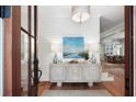Inviting entryway with wood floors, shiplap walls, stylish console table, and ample natural light at 825 Marsh Grove Ave, Mount Pleasant, SC 29464