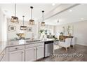 Open-concept kitchen with granite island, pendant lights, seamlessly flowing into the living area at 1008 Drakeford St # 4P, Saint George, SC 29477