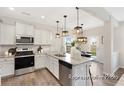Modern kitchen featuring stainless steel appliances, granite countertops, a stylish island, and pendant lighting at 1008 Drakeford St # 4P, Saint George, SC 29477