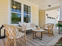 Relaxing covered porch with stylish seating, creating a cozy and inviting outdoor space at 1018 House Finch Ave # Cc3-22-8, Ravenel, SC 29470