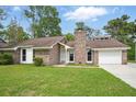 Charming one-story brick home featuring a well-maintained lawn and attached garage under a bright sky at 106 Ruffin Rd, Summerville, SC 29486