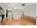 Bright and airy kitchen featuring white cabinets, stainless appliances, a kitchen island, and a view to the backyard at 106 Ruffin Rd, Summerville, SC 29486