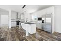 Modern kitchen with stainless steel appliances, a central island, and stylish white cabinetry at 117 Dotson St, Harleyville, SC 29448