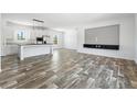 Bright open living area features modern flooring, a stylish media center and abundant natural light at 117 Dotson St, Harleyville, SC 29448