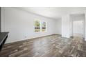 Bright open living area features modern flooring, white walls and abundant natural light at 117 Dotson St, Harleyville, SC 29448
