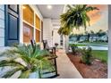 Inviting front porch with comfortable rocking chairs and lush ferns, perfect for relaxing at 119 Loon Dr, Summerville, SC 29483