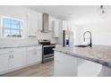Well-equipped kitchen featuring stainless steel appliances, granite countertops, and a stylish kitchen island at 121 Dotson St, Harleyville, SC 29448