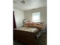 Bedroom with a wooden bed frame, patterned bedding, and a window for natural light at 122 Gator Dr, Goose Creek, SC 29445