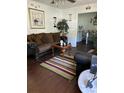 Cozy living room featuring a plush brown sofa, a striped rug, and natural light at 122 Gator Dr, Goose Creek, SC 29445