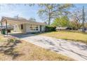 Inviting home featuring a carport and long driveway, complemented by green lawn at 1230 Hawthorne Cir, Hanahan, SC 29410
