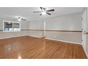 Bright living room with hardwood floors, ceiling fans, and ample natural light from large windows at 1318 Foster St, Charleston, SC 29407