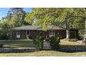 Traditional brick home featuring a cozy entrance and mature landscaping, creating a welcoming appeal at 1328 White Dr, Charleston, SC 29407