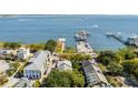 A high-angle view shows the property, neighboring buildings, a pier, and a body of water at 15 N Adgers Wharf, Charleston, SC 29401