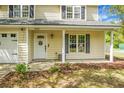 Charming home featuring a white front door and a quaint covered porch entry at 1502 Thoroughbred Blvd, Johns Island, SC 29455