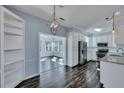 Bright, modern kitchen with stainless steel appliances, white cabinets, granite countertops, and an open view to a sunroom at 1652 Lauda Dr, Mount Pleasant, SC 29464