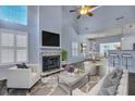 Bright living room with fireplace, vaulted ceiling, modern furnishings, and an open floor plan leading to the dining area at 1652 Lauda Dr, Mount Pleasant, SC 29464