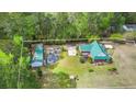 Aerial view of the property showing the house, detached garage and surrounding greenery within the approximate boundary lines at 1694 Jedburg Rd, Summerville, SC 29486